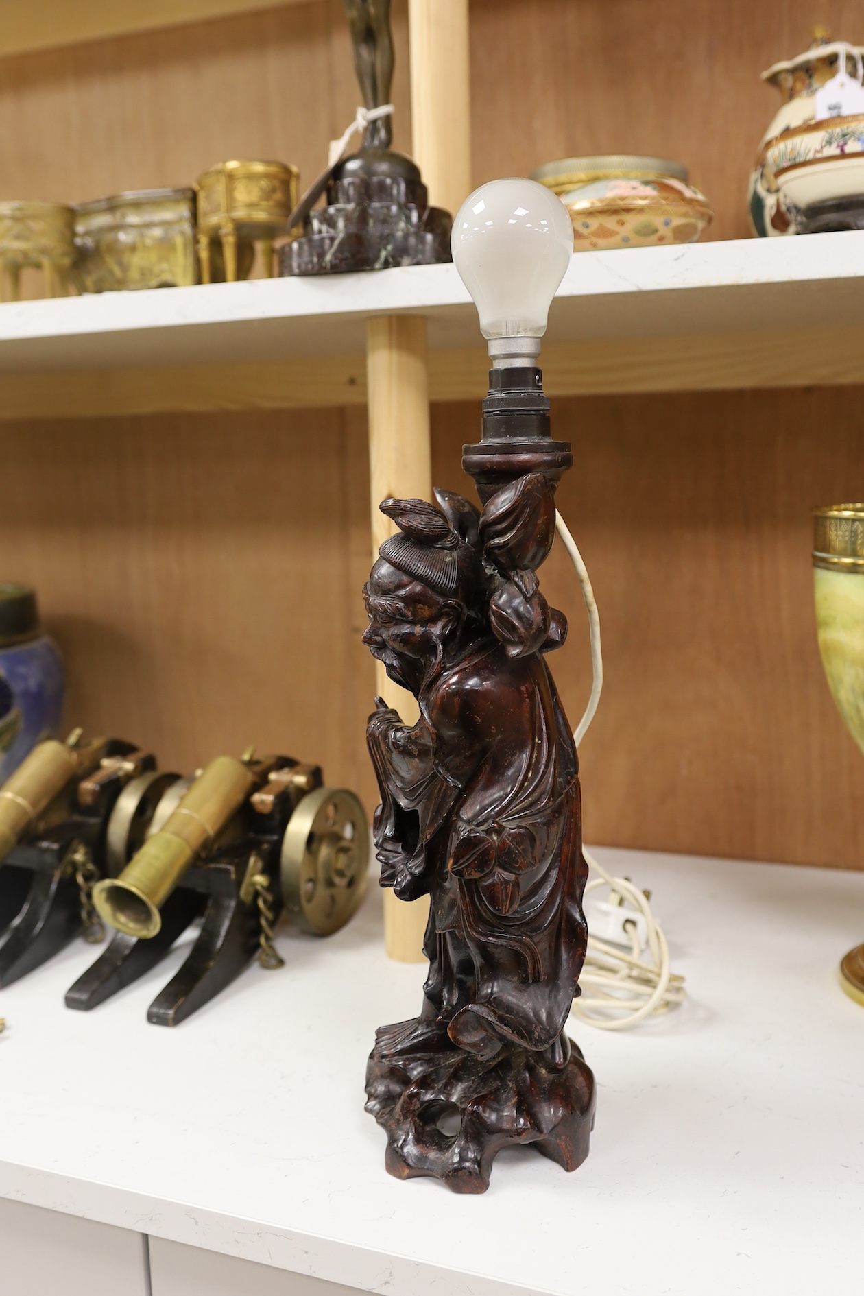 A Chinese carved wooden figural table lamp base, 36cm high not including light fitting. Condition - rubbed in places